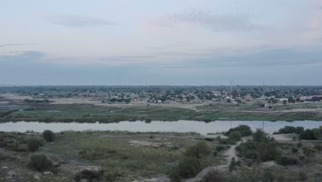 River-flowing-through-small-African-townv