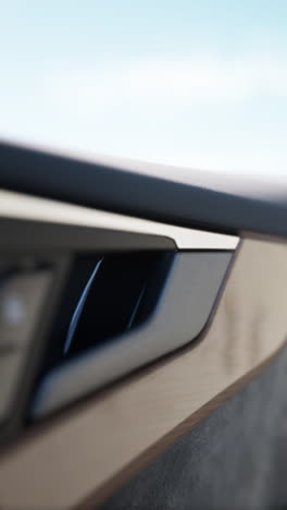 close-up of a car door handle with wood grain and chrome trim