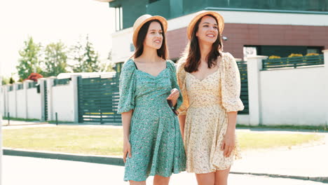 two happy women in summer dresses