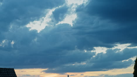 medium wide shot of a sunset without the sun, clouds moving east