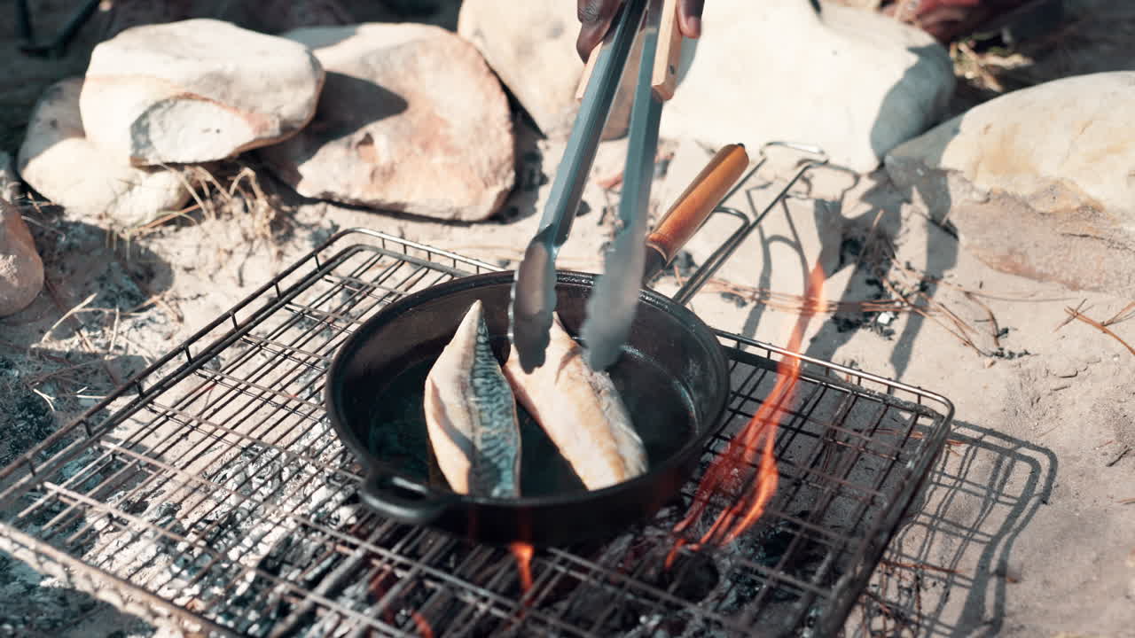 Fish being grilled over a campfire
