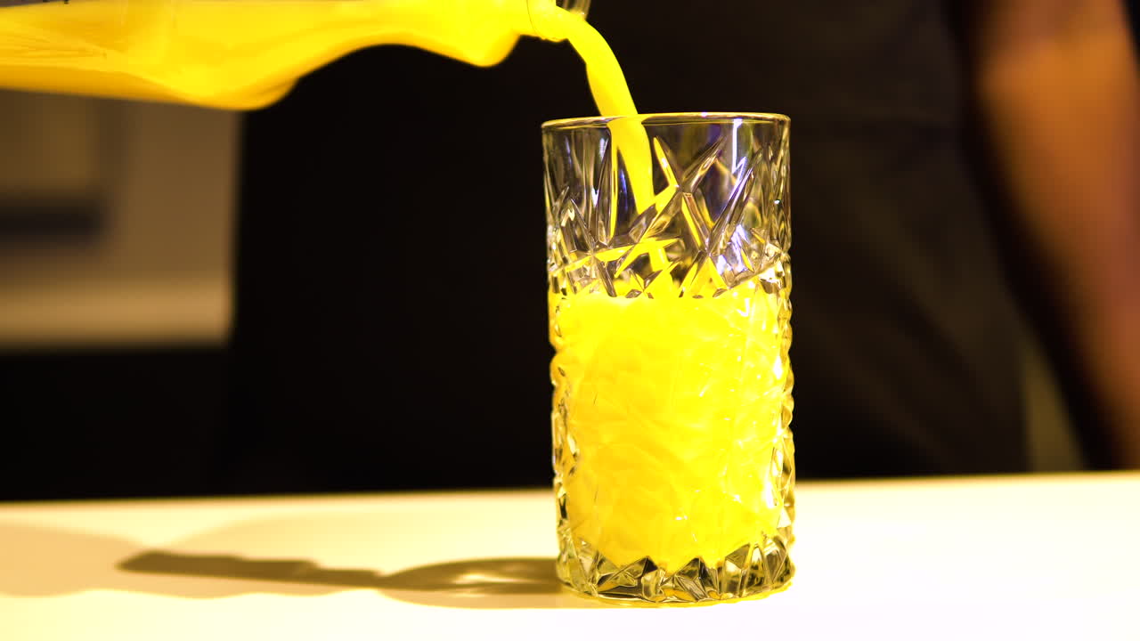 Pouring Orange Juice In A Glass With Beautiful Design - Closeup Shot