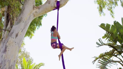 Gorgeous-young-woman-gymnast-working-out-on-silks