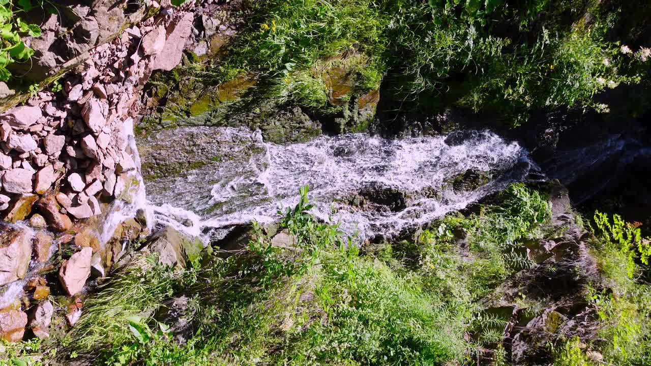 Waterfall formed by a mountain creek flowing over rocks