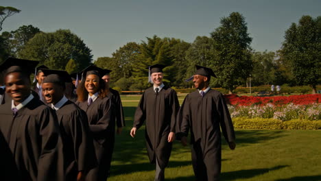 joyful graduates walking outdoors