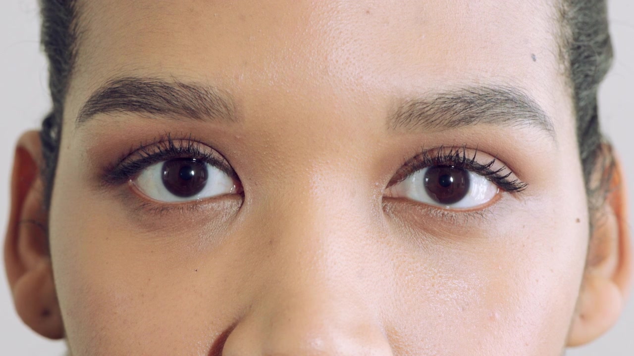 Close-up of Young Woman Opening Her Eyes and Looking at Camera