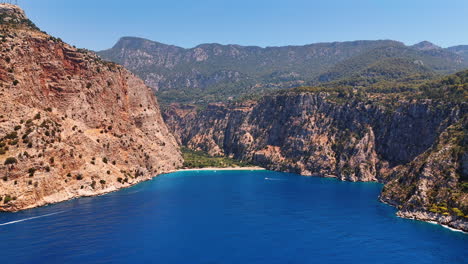 stunning blue waterscape of the mediterranean sea surrounded by the rocks. yachts move by the seascape. turkey nature. aerial view