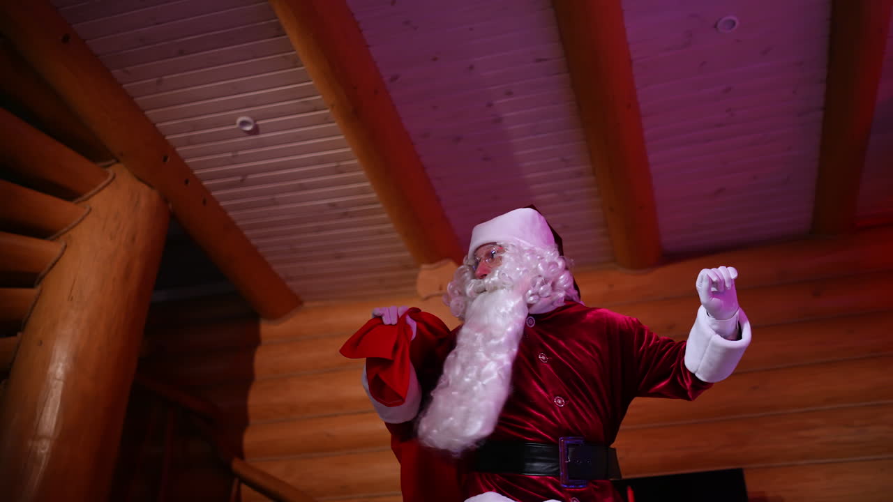 Santa Claus sneaks quietly into the house. Father Frost with red sack with presents walking around the wooden house at New Year's eve. Christmas time.