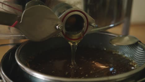 Pouring-Freshly-Made-Honey-at-Apiary-Bee-Yard