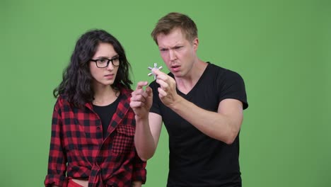 young couple playing with fidget spinner together