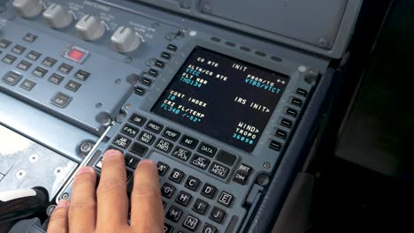 pilot checking parameters on mcdu-multipurpose control display unit