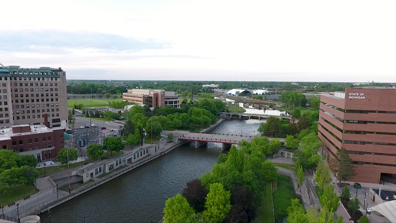 Un drone riprende immagini volando verso nord sopra Saginaw Street e il fiume Flint a Flint, Michigan