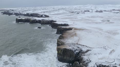 arnarstapi village in snaefellsnes with a beautiful coastline and gatklettur at wintertime in iceland