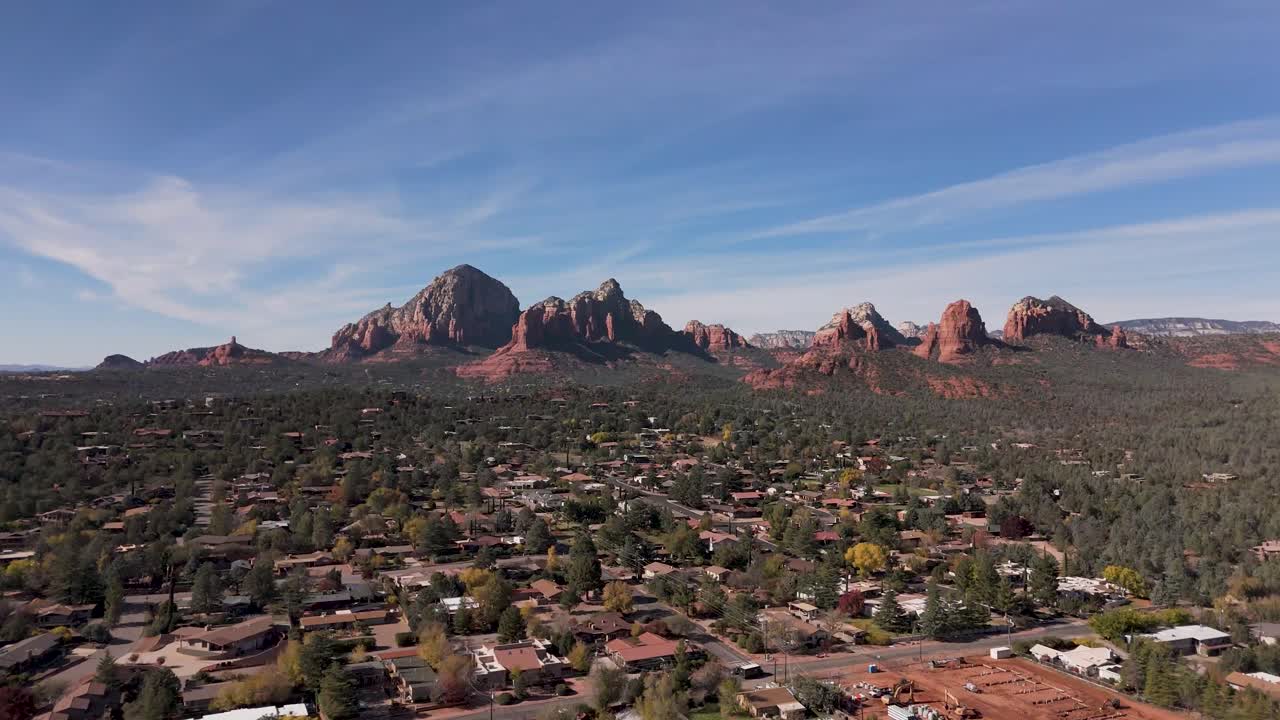 A stunning aerial view of Cathedral Rock, one of Sedona's most recognizable landmarks, standing tall amidst the dramatic desert landscape