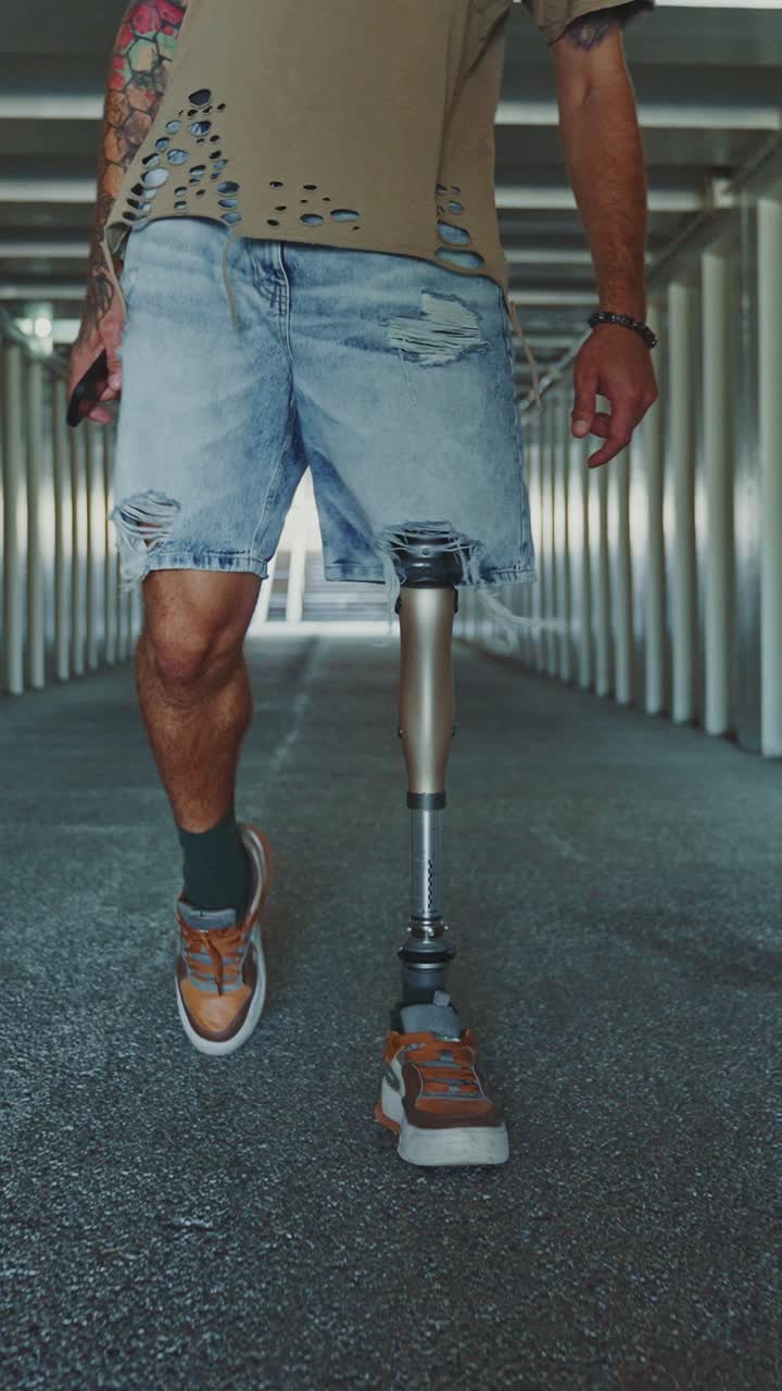 Man with Prosthetic Leg Walking Through a Tunnel