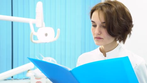 female dentist reviewing patient records