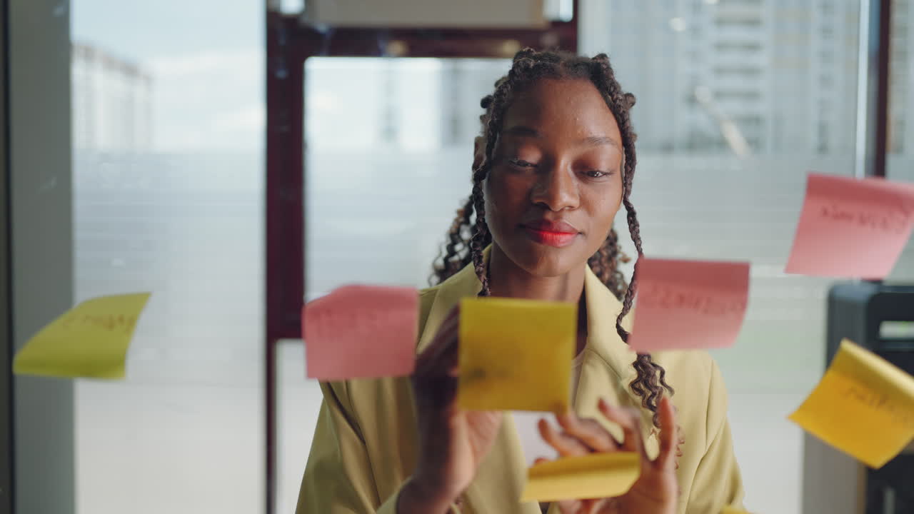 African American Business Woman Write Tasks Creative Ideas On Sticky Notes On Glass Board Female Corporate Leader Planning Project On Post It Sticky Notes Organize Work On Stickers