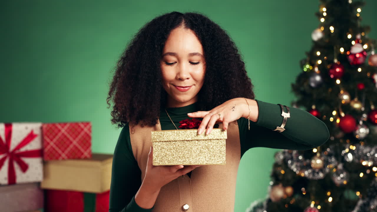 mujer emocionada abriendo el regalo de navidad