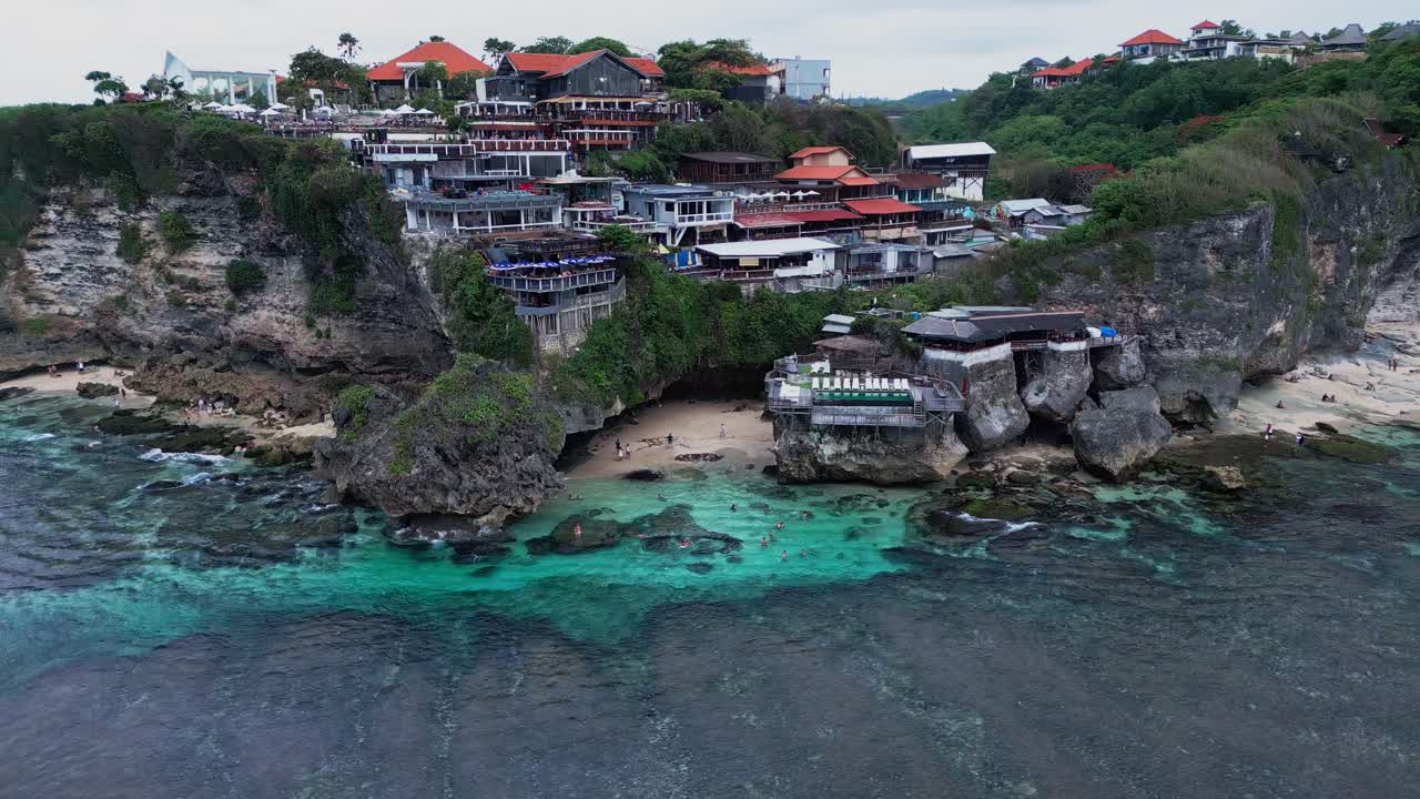 Uluwatu Blue Point features towering cliffs and a vibrant blue ocean known worldwide as a top surfing spot where waves attract surfers seeking adventure and stunning coastal views.