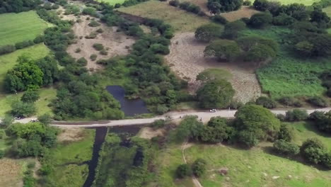 Aerial-shot-of-a-vast-green-region-and-small-bodies-of-water