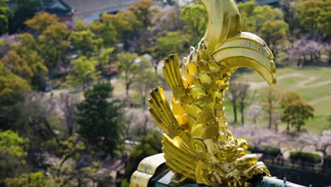 slow motion panning shot of golden accents on the osaka castle, japan