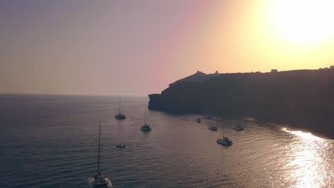 Red-Cliff-Bay-Yachts-at-Sunset,-Greek-Islands