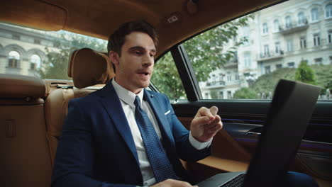 Annoyed-business-man-talking-on-video-call-in-car.-Ceo-arguing-in-video-chat