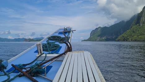 bow of boat sailing between remote exotic tropical islands