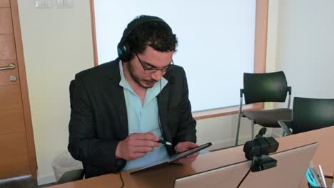 brainstorming solutions: man with tablet and headset