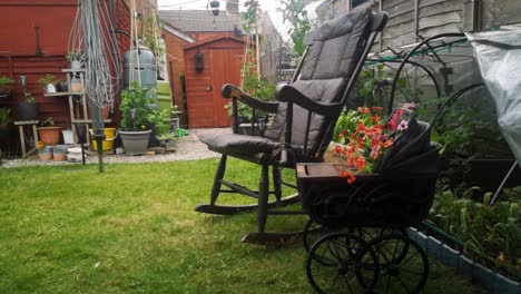 Rustic-rocking-chair-and-spooky-gothic-wooden-pram-planter-in-peaceful-idyllic-English-garden-shade