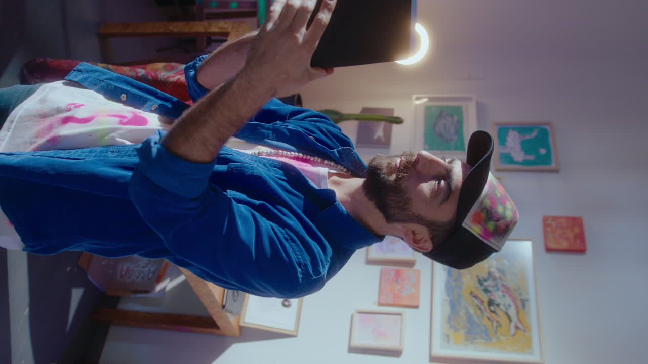 Male Artist Looking at Sketches Drawn on Paper Harmonica