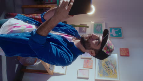 male artist looking at sketches drawn on paper harmonica