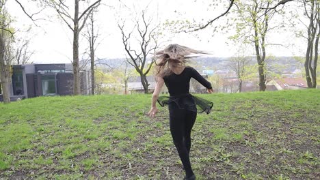 beautiful dancer performing in a green park