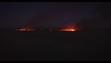 australian desert bush fire at night from aerial drone