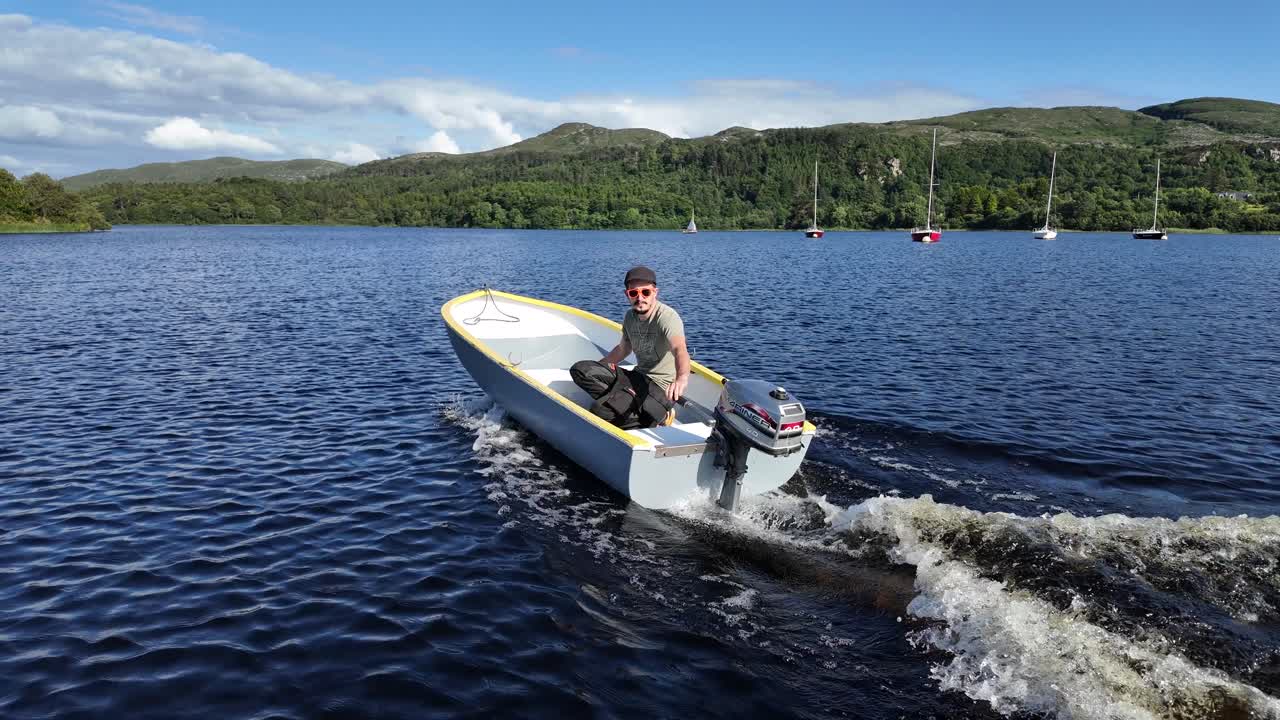 Man Driving a Small Boat, Leaving a Wake on a Calm Lake
