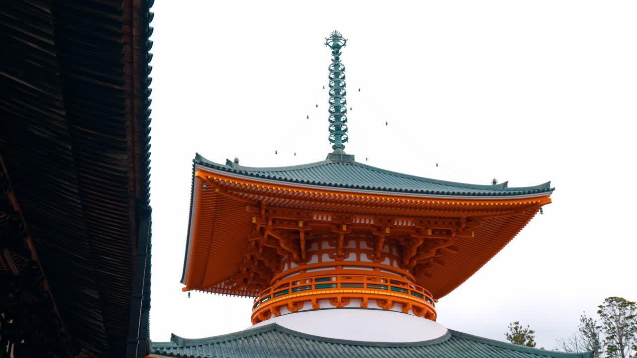 A cinematic shot of the iconic temple pagoda in Danjo Garan, located in the serene Mount Koya, Koyasan, Japan.