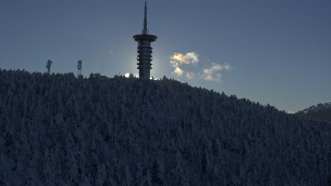 aerial - telecommunications tower on snowy mount parnitha against sunlight - shot on dji inspire 2 x7 raw