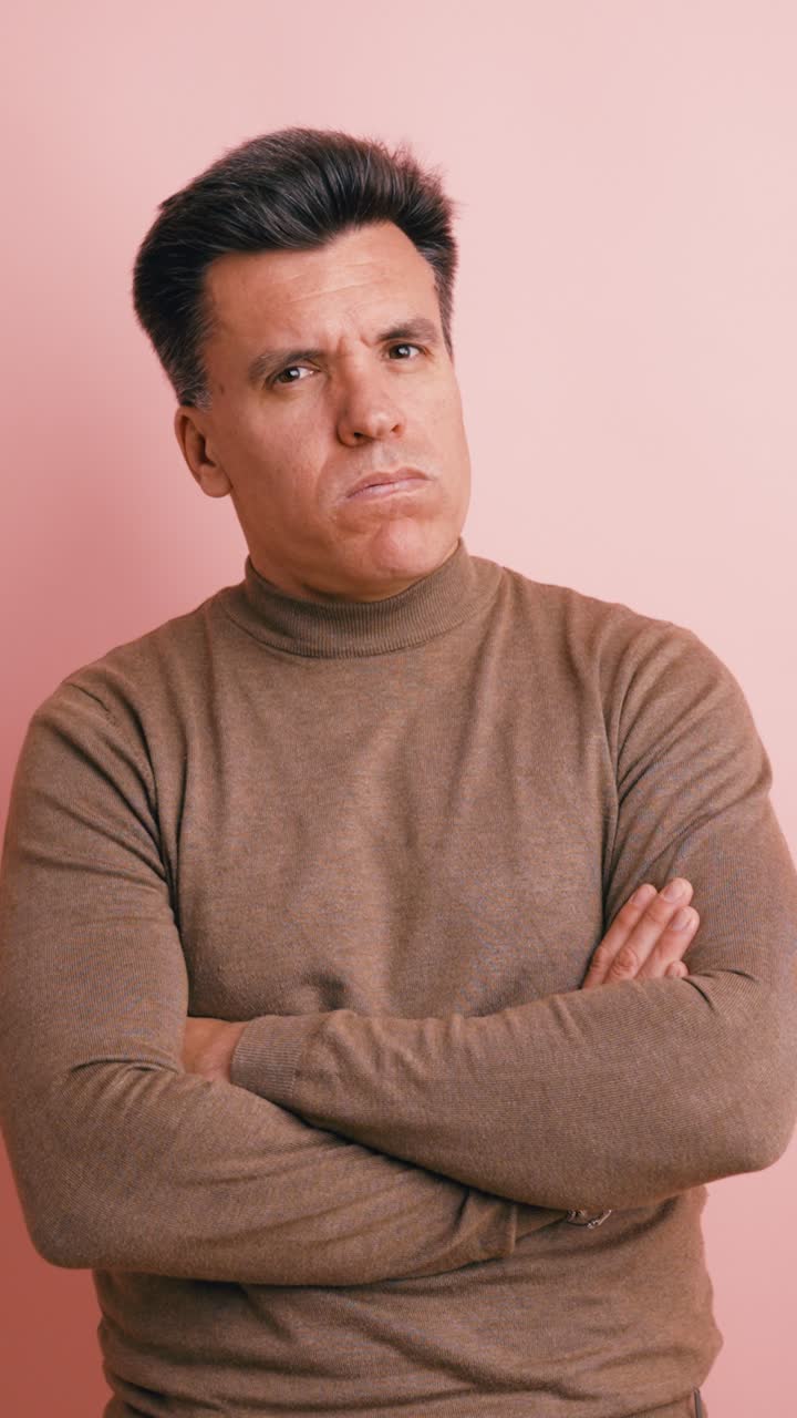 Middle-Aged Man with Arms Crossed Showing Skepticism and Disapproval
