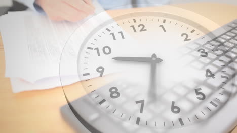 animation of clock moving over hands of caucasian businesswoman writing