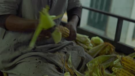 happy man is selling corn on the street