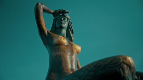 bronze statue of a female figure gazing into the distance