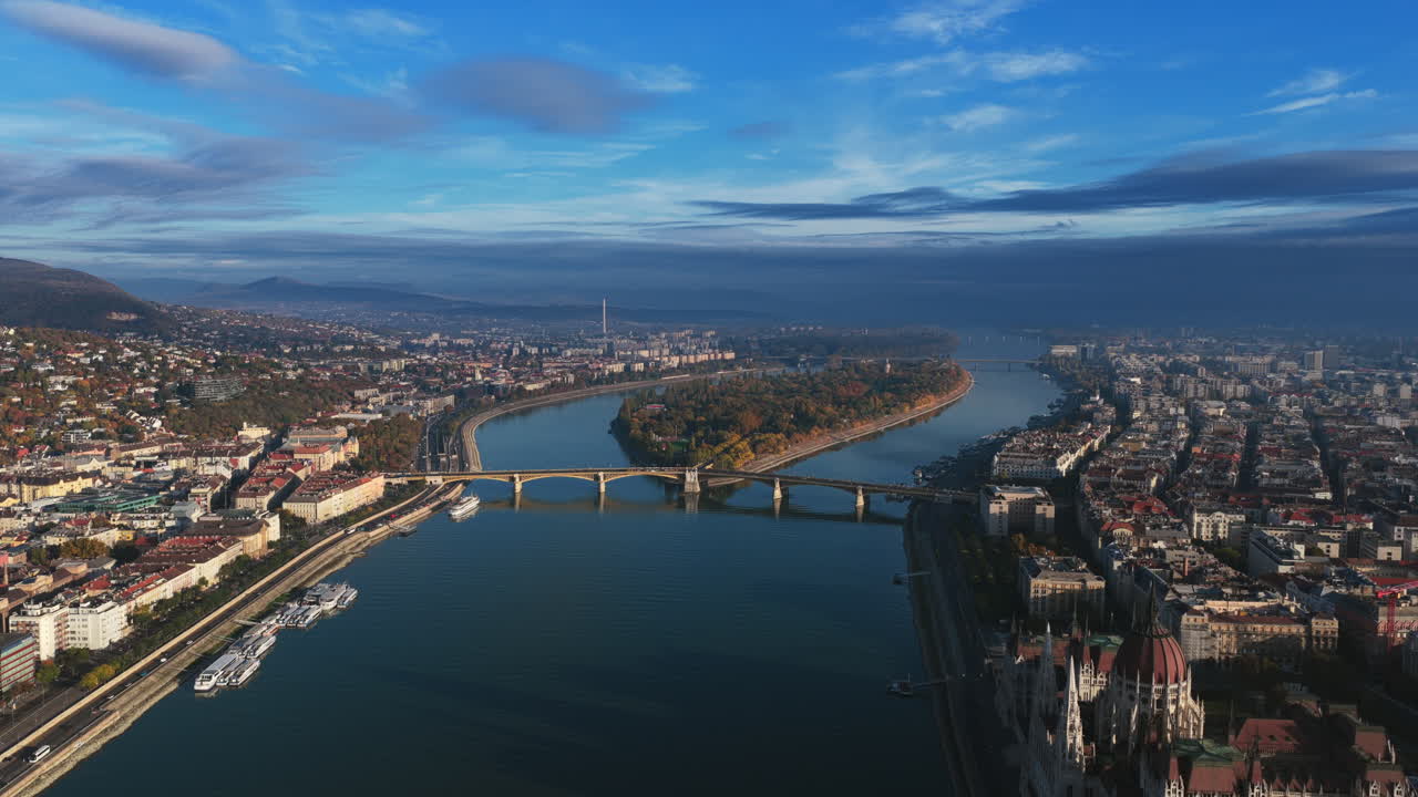 Soft daylight over Budapest’s Parliament and the Danube captures calm reflections and the city’s serene autumn hues