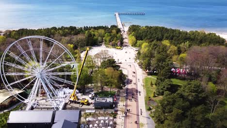 Massive-Ferris-wheel-under-construction-near-Basanavicius-street-in-Palanga,-aerial-view