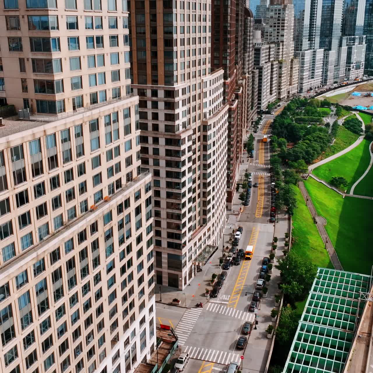 Freeway with heavy traffic at the waterfront of New York. Drone flight along the multistoried buildings facing the East River