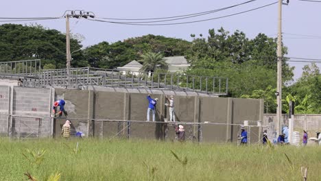 team of workers collaboratively building a concrete wall.