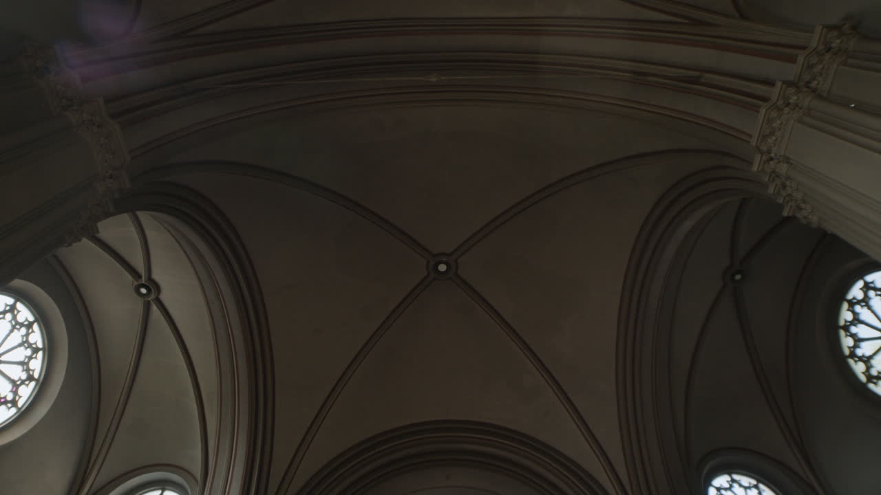 Architectural details of a church ceiling with arches and rose windows