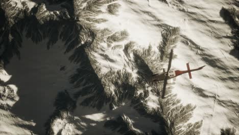 helicopter above mountains in snow