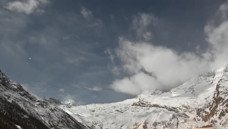 Timelapse:-clouds-moving-fast-over-the-snowy-alps-mountains-in-Saas-Fee,-Switzerland,-Valais