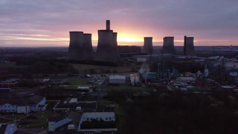 fiddlers ferry disused coal fired power station at sunrise glowing behind warrington landmark, aerial view