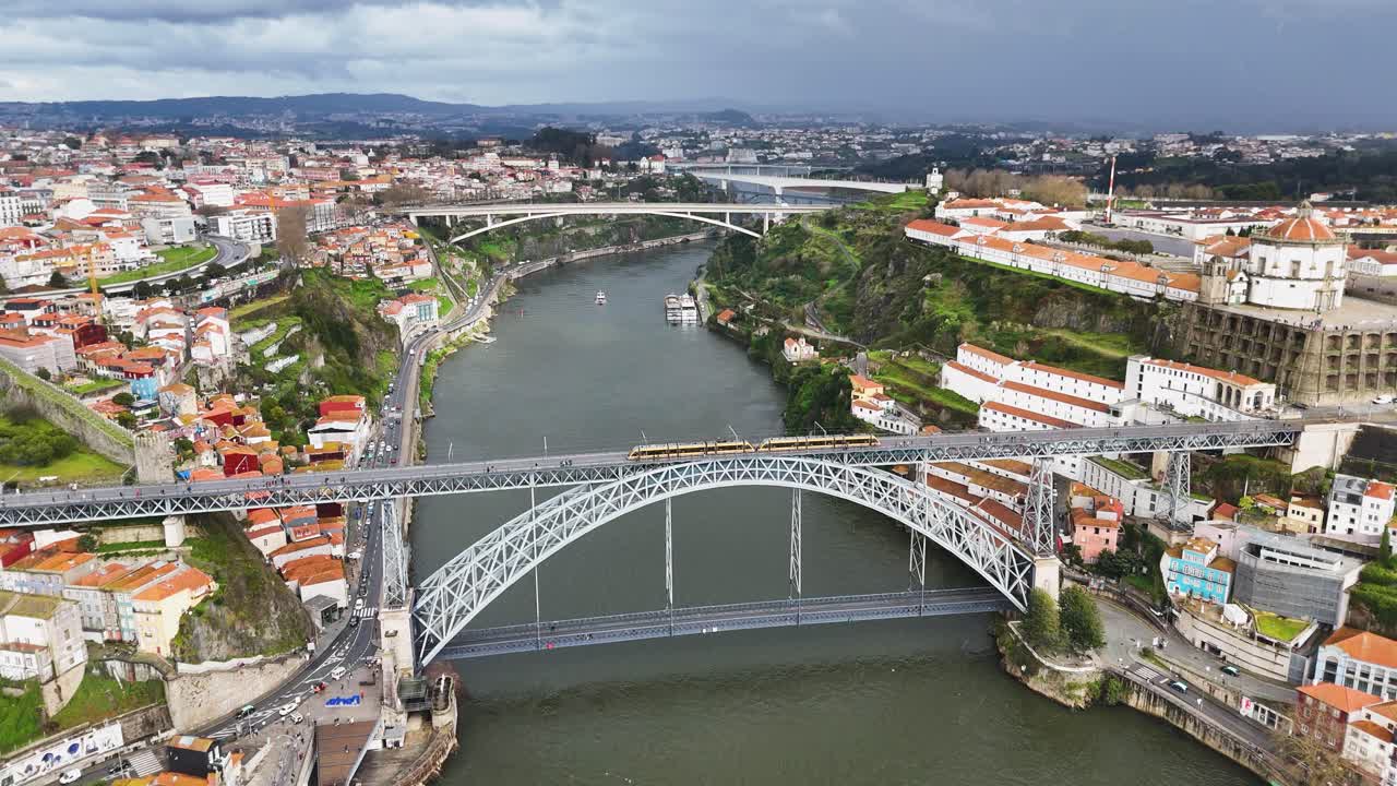Scenic Porto cityscape with historic bridge and yellow tram